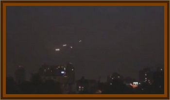 Four Sets Of Glowing Lights Floating Above Santiago